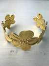 close-up of gold-coloured floral cuff bracelet