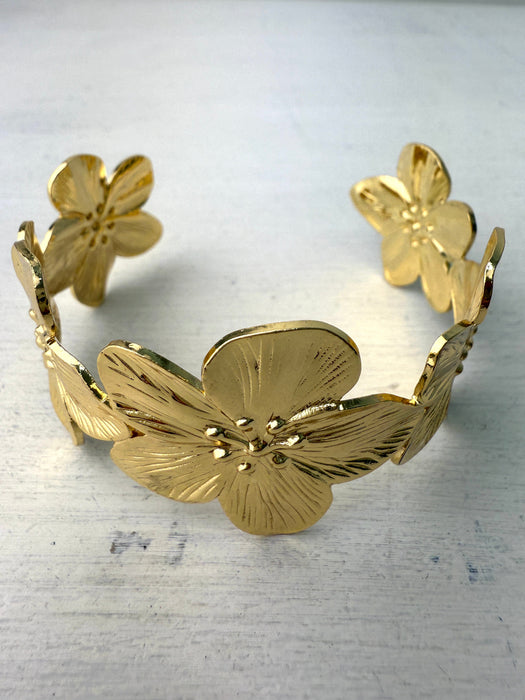 close-up of gold-coloured floral cuff bracelet