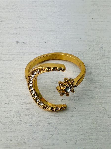 gold-tone ring featuring a crescent moon and star with sparkling crystals.