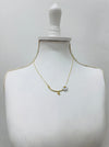Gold necklace on a mannequin bust against a white background