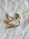 gold dove brooch with olive branch symbol of peace