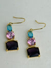 Elegant gold dangle earrings with faceted purple, pink and blue crystals.