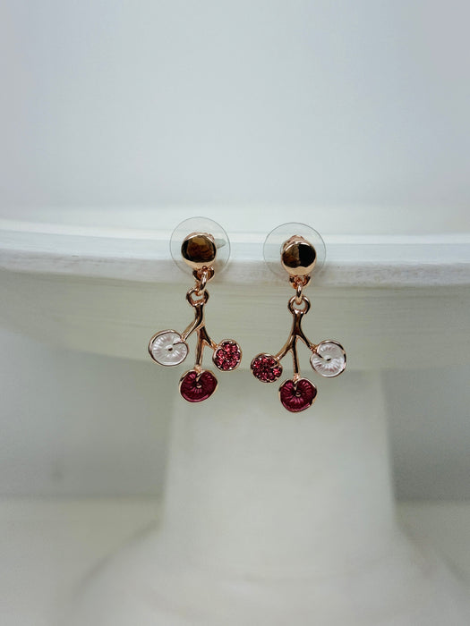 Rose-gold floral enamel drop earrings with gold tone finish, displayed on a white background.