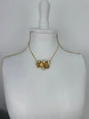 Gold necklace on a mannequin bust against a white background