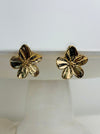 front view of gold flower-shaped earrings 