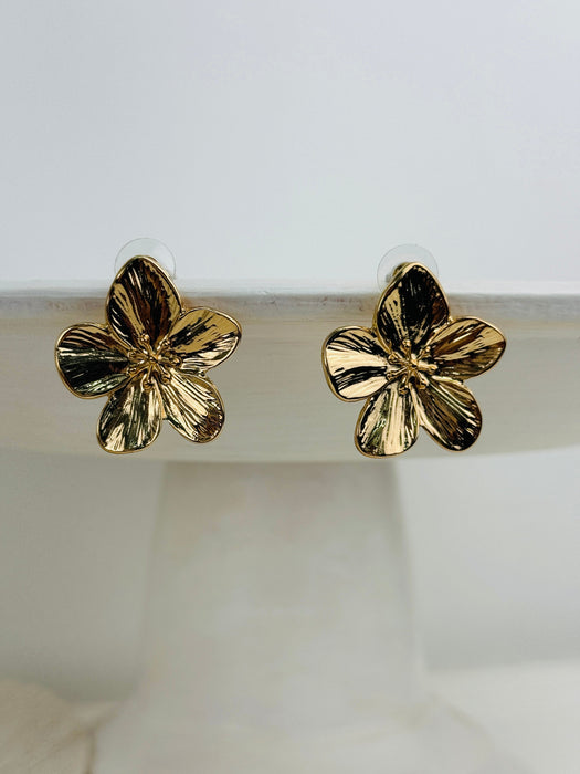 front view of gold flower-shaped earrings 