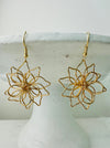front of gold flower wire dangle earrings