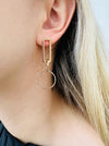 close-up of gold geometric rectangle circle drop earrings 