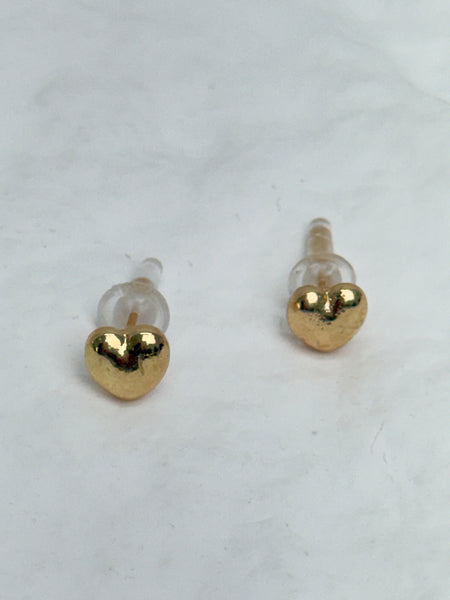 Gold heart-shaped earrings on a white background