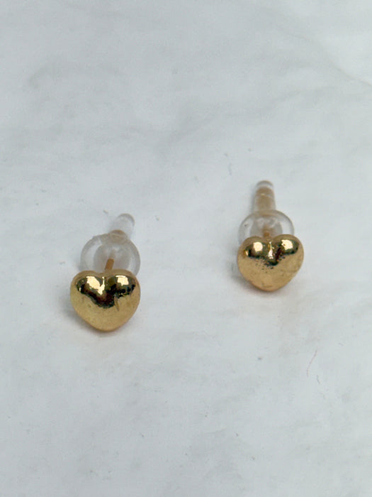 Gold heart-shaped earrings on a white background