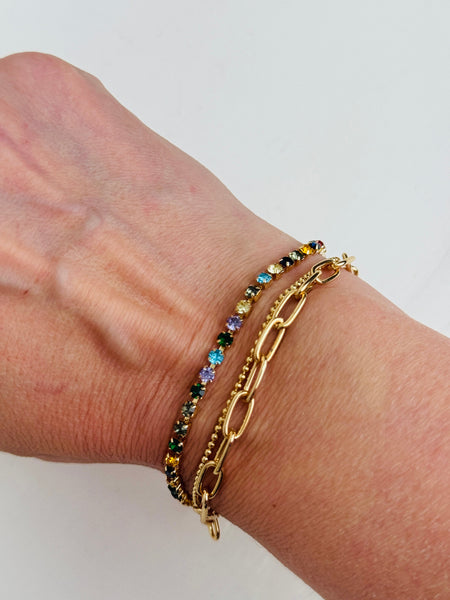 Gold bracelet with colourful gemstones displayed on a model