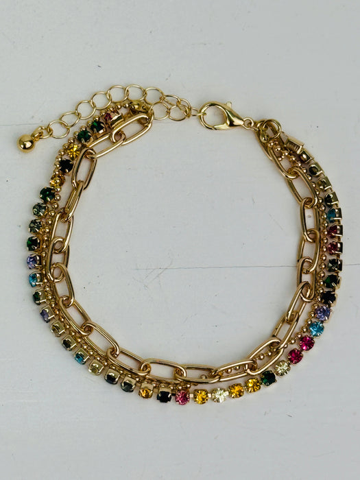 Gold chain bracelet with multicolored gemstones on a white background