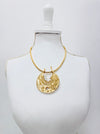 Modern gold tone necklace with organic textured pendant and natural pearl details.