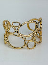 front view of gold-tone openwork cuff bracelet with abstract organic shape