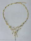 Gold and silver-tone abstract necklace with interwoven curved bars and adjustable chain on white background.