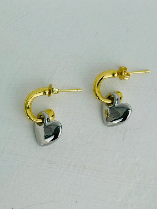 Gold and silver heart-shaped hoop earrings on a white background