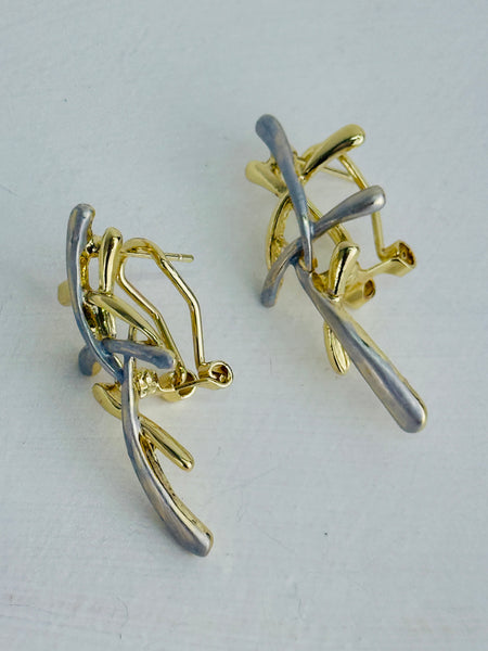 Gold and silver tone abstract earrings with interwoven curved bars.