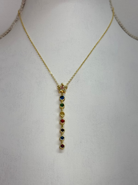 front of gold star necklace with multicolour gemstone drop pendant.