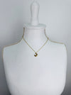 Gold necklace with a moon and star pendant on a mannequin 