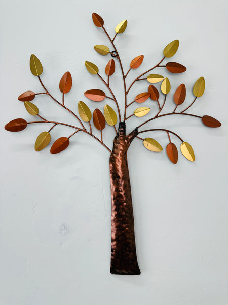 Decorative metal tree wall art with autumn leaves on a white background
