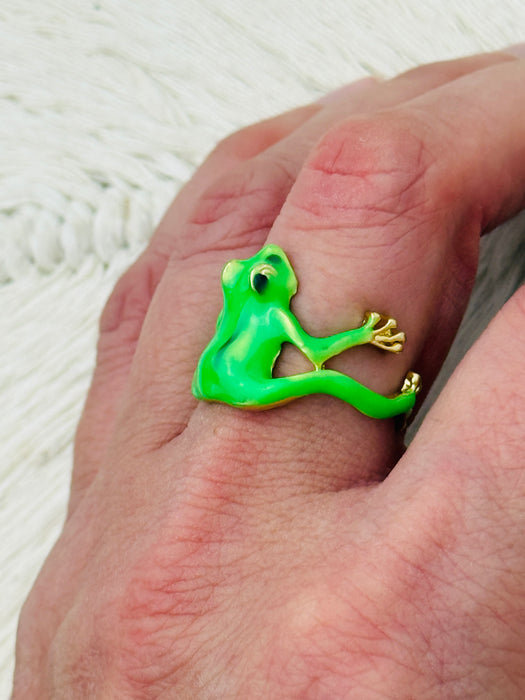 Green enamel frog adjustable ring with gold-tone details, displayed on a model.