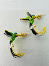 Hummingbird-shaped earrings with gold accents on a light gray background