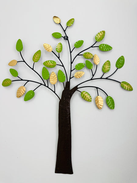 Decorative wall art of a tree with green and gold leaves on a white background
