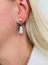 Grey and gunmetal rectangular enamel drop earrings with silver-tone outline, displayed on a model.