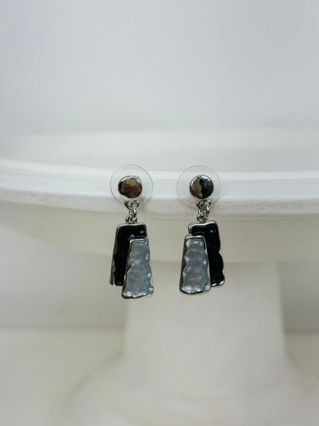 Grey and gunmetal rectangular enamel drop earrings with silver-tone outline, displayed on a white background.