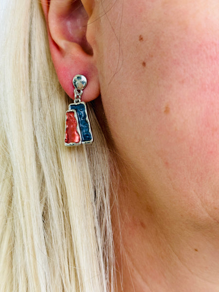 Gunmetal and bronze rectangular enamel drop earrings with a silver-tone outline, displayed on a model.