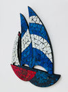 side angle of mosaic sailboat wall art with blue, white, and red colors on a white background
