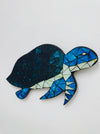 Mosaic turtle sculpture on a white background