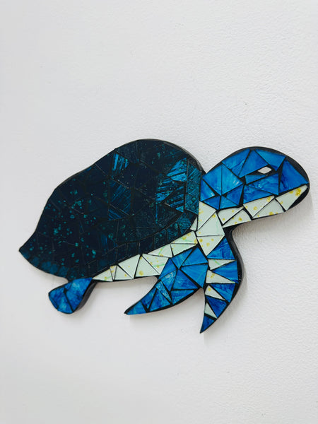 Mosaic turtle sculpture on a white background