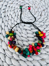 A vibrant delicate handmade wood bracelet with bright wood bead flowers.