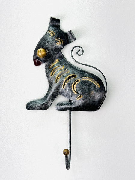 Side view of handmade silver dog wall hook with gold accents.