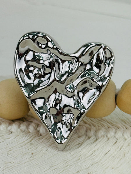 close-up of silver heart-shaped brooch