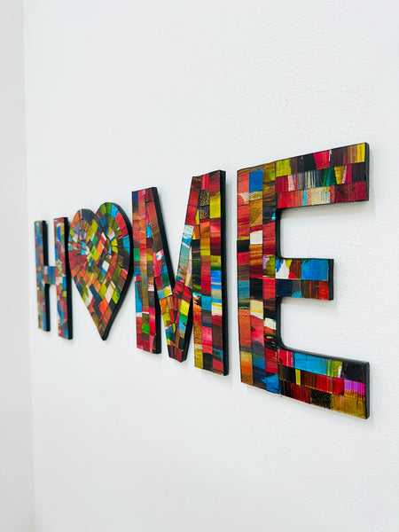 HOME mosaic wall art with heart-shaped O in fragaria tones on MDF base