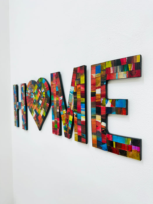 HOME mosaic wall art with heart-shaped O in fragaria tones on MDF base