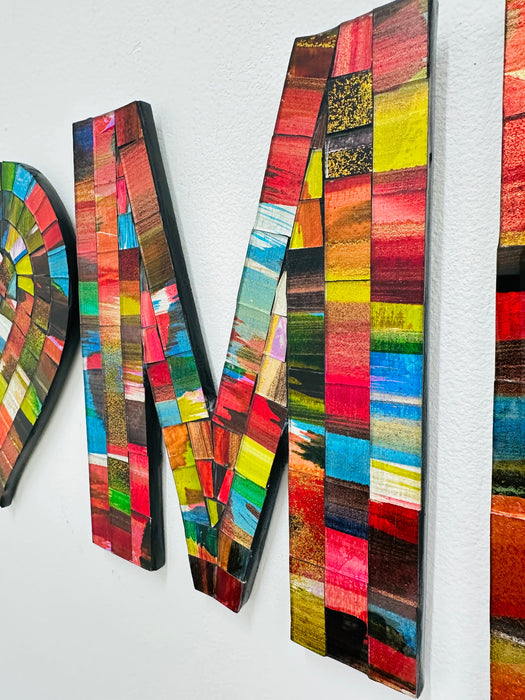 close-up of mosaic letter 'M' on a white background