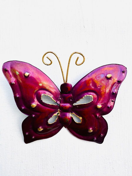 front view of metal butterfly in magenta on white background