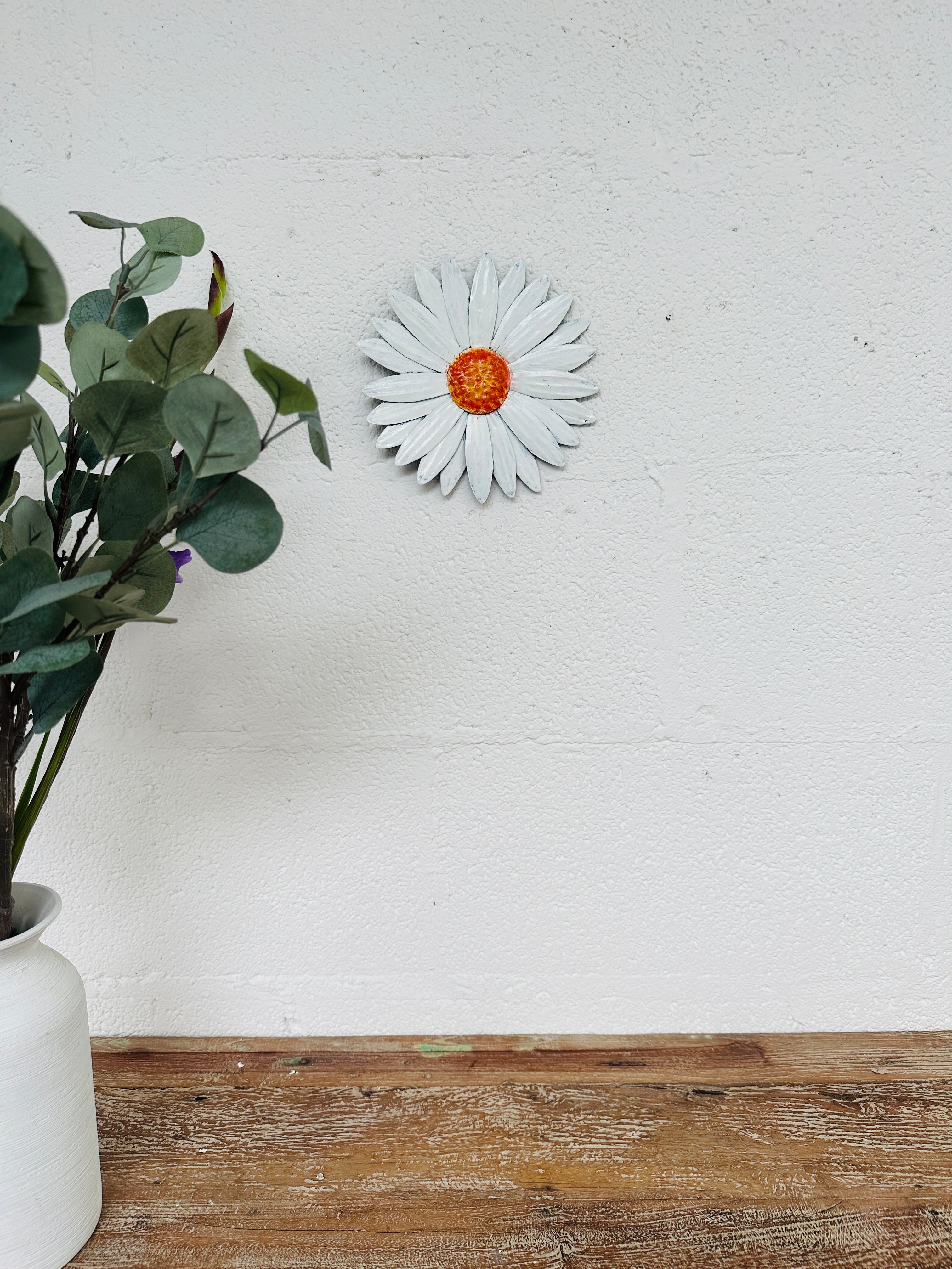 display view of metal daisy flower on wall