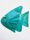 front view of single metal fish in turquoise