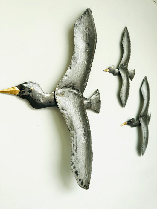 side view of metal flying birds 