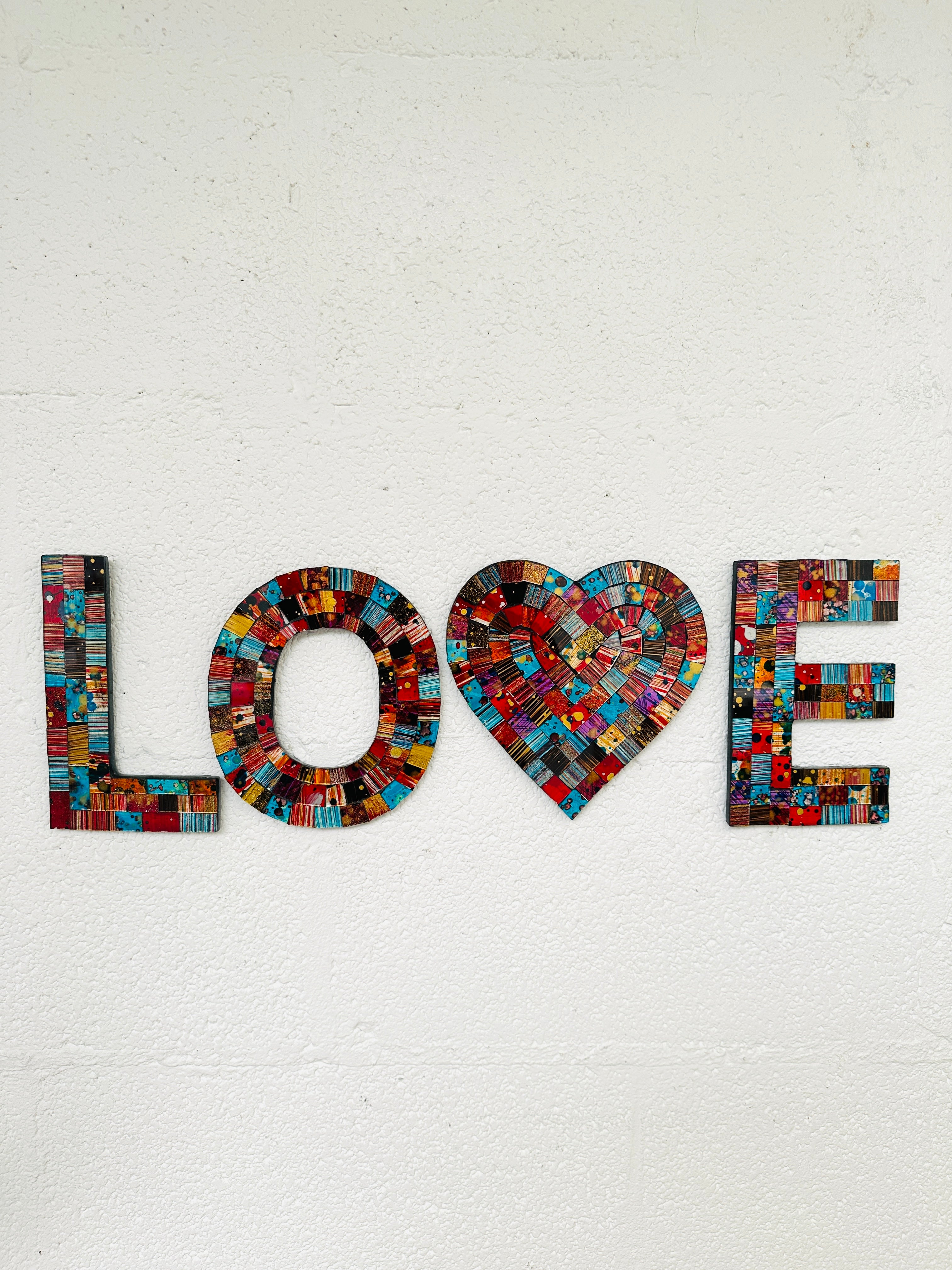 front view of mosaic love on white wall