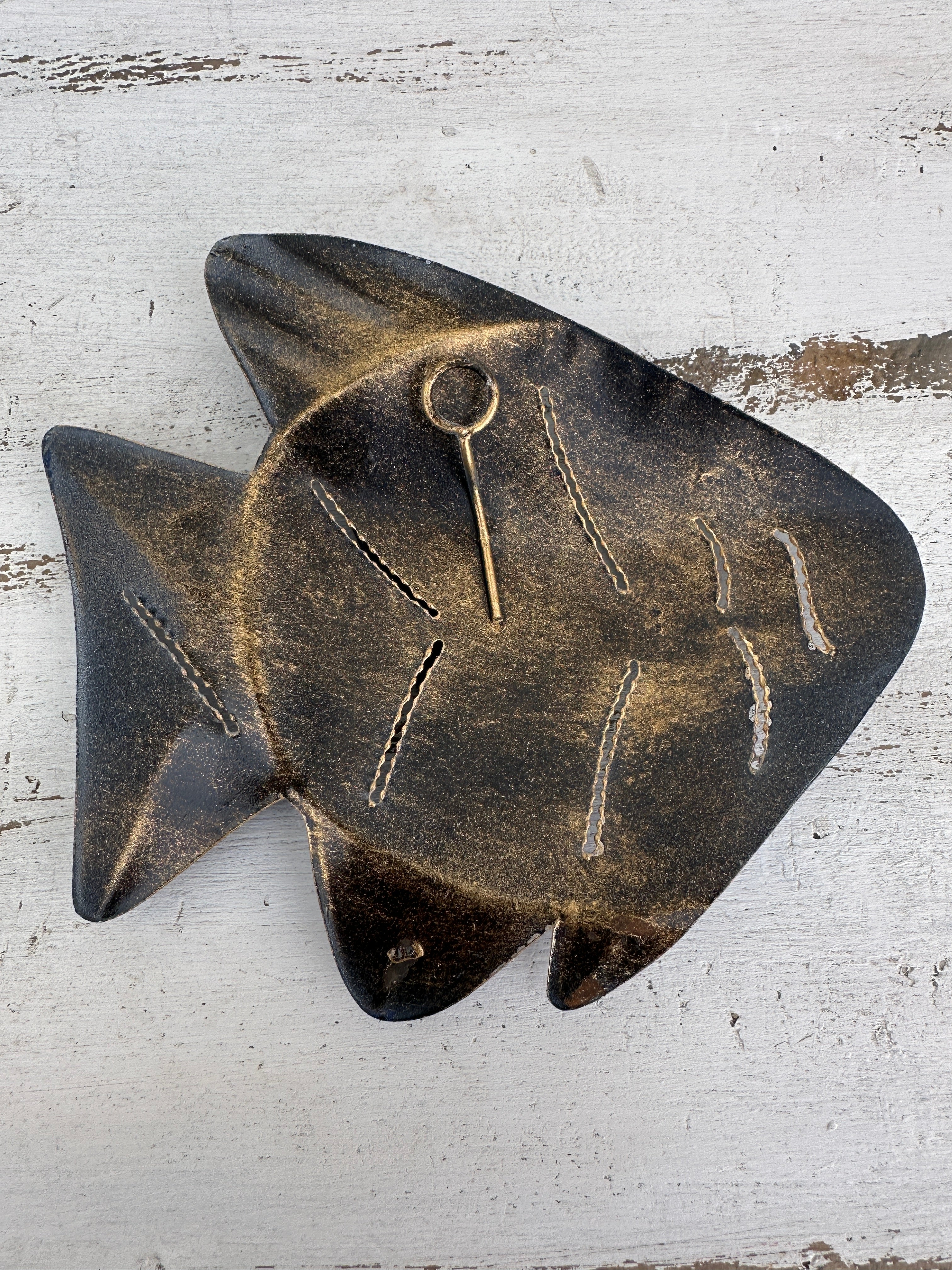 aerial base view of metal fish with hook attached