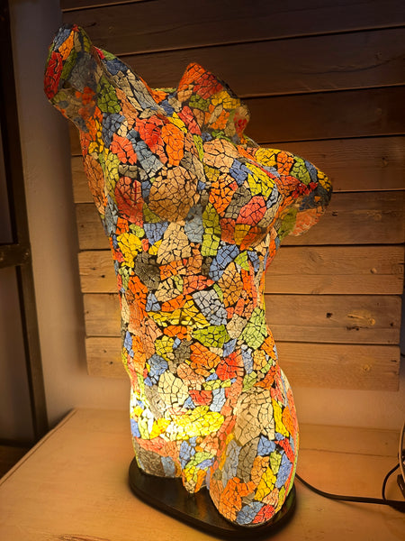 front view of mosaic man body lamp with light on 