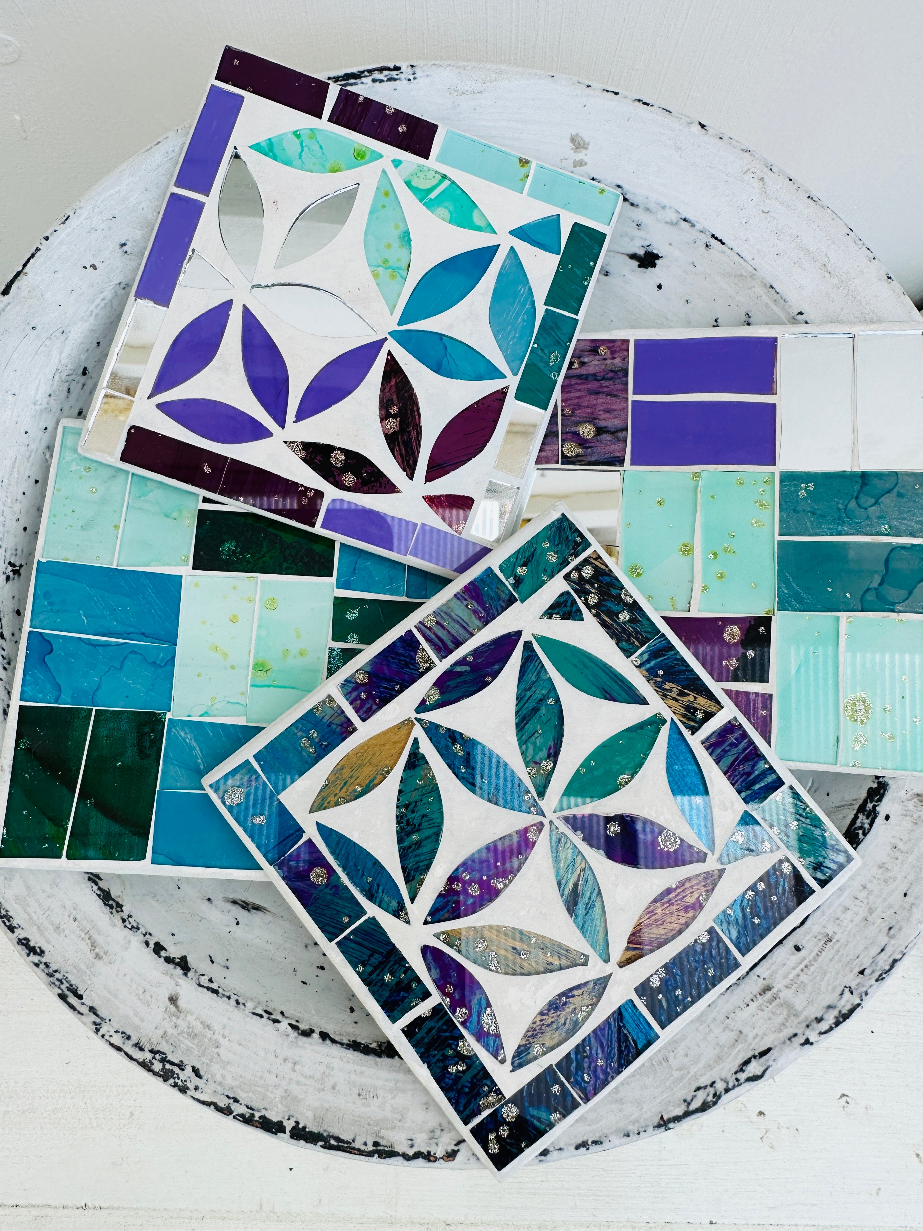 display view of set of assorted square mosaic coasters on white background