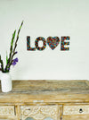 front view of mosaic love attached to a wall
