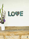 front view mosaic love letters displayed on the wall