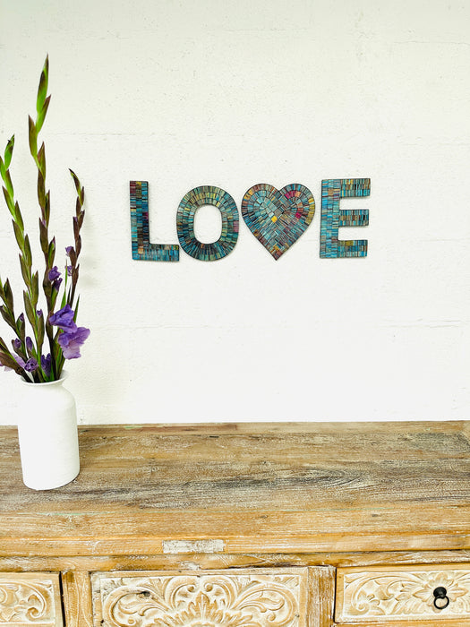 front view mosaic love letters displayed on the wall